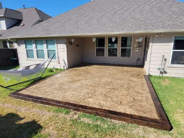 A house featuring a stamped concrete patio built by TJ Concrete Contractor team in Sugar Land, TX